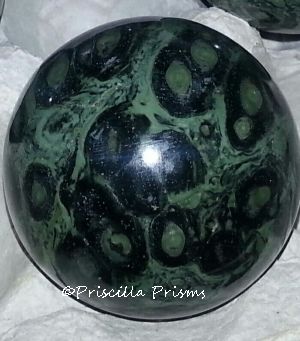 Colorful orbs of turquoise and black jasper set in crystalline matrix
